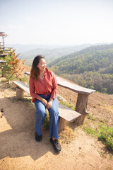female smile and sitting on chair mountain