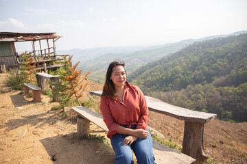 female smile and sitting on chair mountain