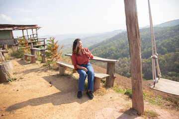 female smile and sitting on chair mountain