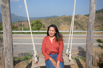 Smiling Woman On Swing