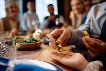 Close up of Jewish grandfather giving his granddaughter gelt on Hanukkah.