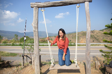 Smiling Woman On Swing