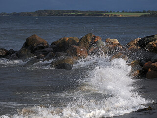 Wellen branden an Felsen, Steine an der Ostsee,