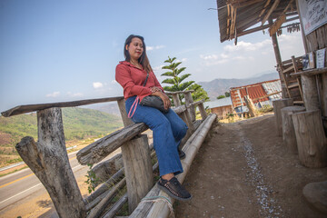 female smile and sitting on chair mountain
