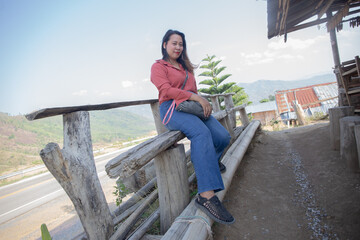 female smile and sitting on chair mountain