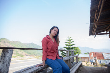 female smile and sitting on chair mountain