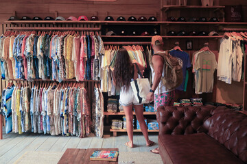 two people tourists shopping in tamarindo beach in a local shop 