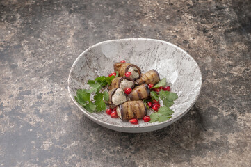 mini eggplant rolls stuffed with cheese and walnuts in gray plate