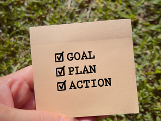 New Year motivational concept. GOAL, PLAN and ACTION written on notepad. With blurred styled background.