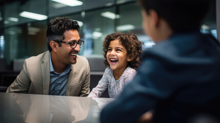 A parent and child exchanging smiles and laughter while meeting with an educational consultant. - obrazy, fototapety, plakaty