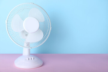 Electric fan on blue background