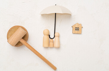 Wooden family figures with judge's gavel on concrete background,top view