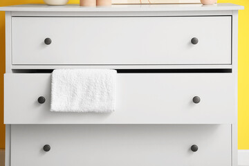 White chest of drawers with towel, closeup