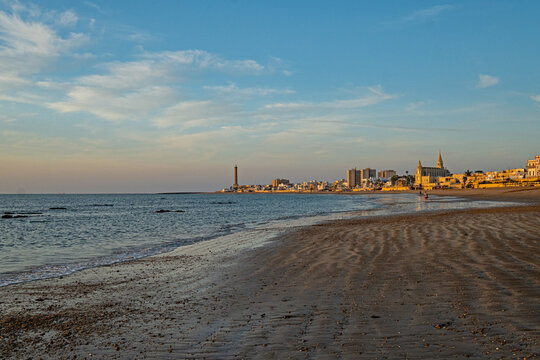 Regla beach with church and lighthouse in Chipiona in warm evening light