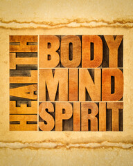health, body, mind and spirit word abstract - a collage of text in vintage wood letterpress printing blocks on art paper, wellbeing and personal development concept