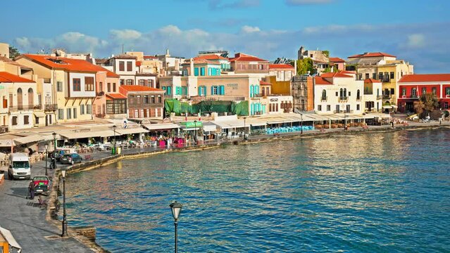 View of the colourful Old Venetian Port of Chania in Crete, Greece. Chania Harbour surrounded by turquoise-blue water, restaurants and colorful houses in Chania, Greece.