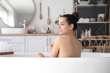 Young woman taking bath at home