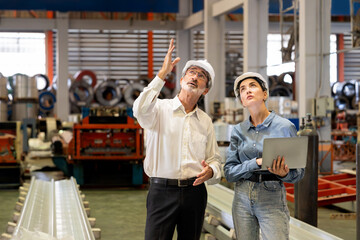 Factory manager or executive make visit metalwork manufacturing factory tour and inspect heavy...