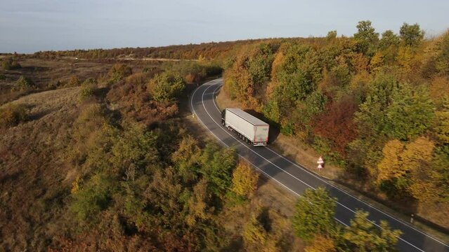 Aerial Drone View truck Drive on Curvy Mountain asphalt Road in Autumn