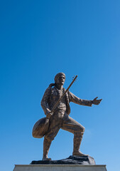 Karacaoglan statue in Adana. Turkey. Blue sky background.
