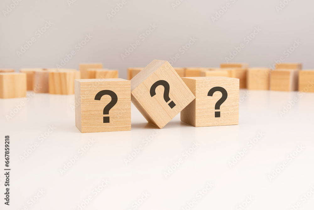 Aufkleber row of three wooden blocks question marks on viewed angle on a white background