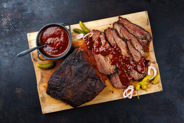 Traditional smoked wagyu beef brisket served with vegetable and spicy barbecue Louisiana sauce...