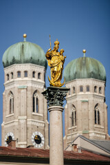 Fototapeta na wymiar A towering column in Marienplatz, topped by a statue of the Virgin Mary