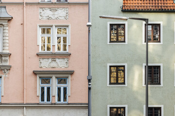 A pink and a green house facade of an old buildings in Munich, Germany