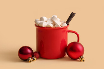 Cup of hot cocoa with marshmallows and Christmas balls on yellow background