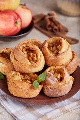 Naklejka na ściany i meble Rose shaped mini open pies with apples, cinnamon and brown sugar. Delicious homemade sweet buns.