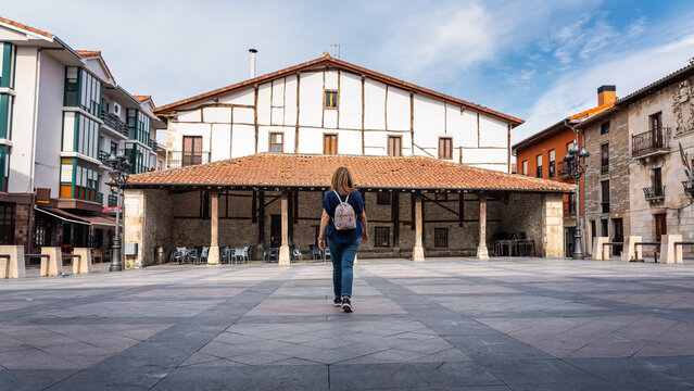 Tourist woman visiting the main square of the picturesque village of Salvatierra, Basque Country, Spain.