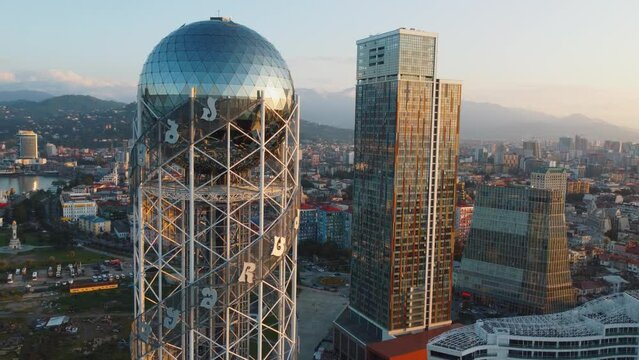 Aerial photography from flying drone of Alphabet Tower and embankment in Batumi, Georgia Flight over tallest towers and skyscrapers of Batumi. Beautiful view from above of city of Batumi, Georgia sea.