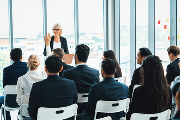 Group of business people meeting in a seminar conference . Audience listening to instructor in employee education training session . Office worker community summit forum with expert speaker . Jivy