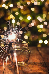 Christmas background with sparkler in a jar