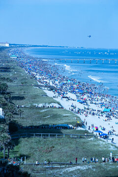 JACKSONVILLE BEACH, FL – OCTOBER 22.  Crowds gather to watch the Blue Angels perform a show over Jacksonville Beach for their Sea & Sky event in Jacksonville Beach, Florida – 22 Oct 2023