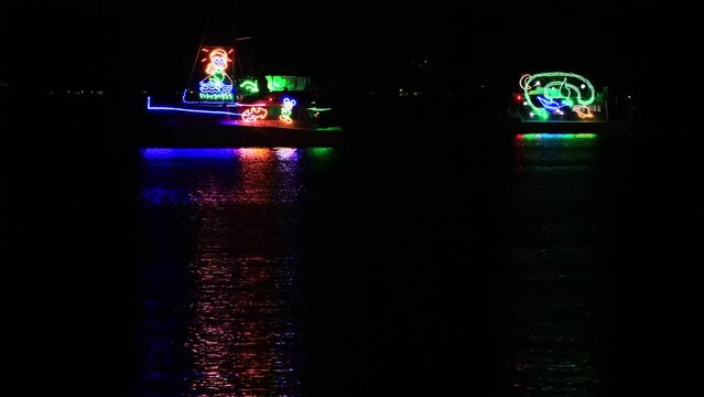 Fluoro fleet bright night on Lake Macquarie at Warners bay beach in Australia 4k.
