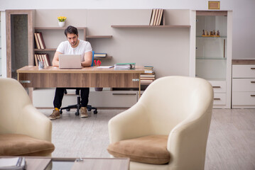 Young male employee working from home during pandemic