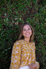 Fototapeta premium attractive and smiling young girl in orange blouse