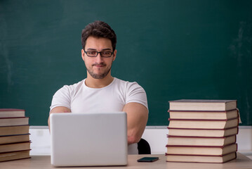 Young male student sitting in the classroom