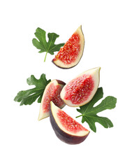 Piece of fresh fig and green leaves falling on white background