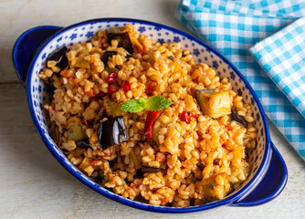 Traditional delicious Turkish food; Bulgur pilaf with eggplant and vegetables. (Turkish name; Patlicanli bulgur pilavi)