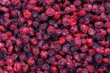 Dry red pitted cherries in the background, closeup, top view. A way to preserve vitamins. Cherry...