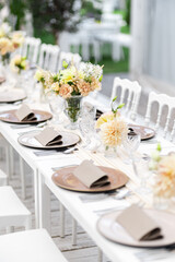 Beautiful table set for an event party or wedding reception . restaurant interior	