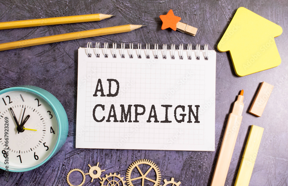 Poster ad campaign text on a paper with keyboard on grey background.
