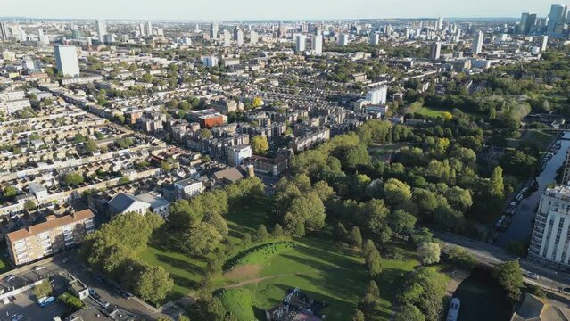 Drone video of a green park and residential blocks of houses in London.