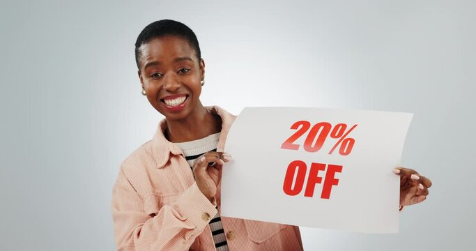 Sale, promotion and woman with sign for discount, advertising and paper billboard on white background in studio. Happy, customer and announcement of sales on poster, banner or mockup space for deal