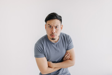 Confused face of asian man in blue t-shirt stand isolated on white.