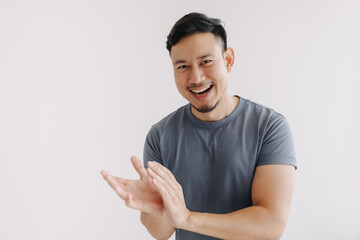 Happy asian man in blue t-shirt and jeans clapping hands stand isolated on white