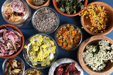 Many different herbs in bowls on blue wooden table, flat lay