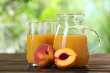 Tasty peach juice and fresh fruits on wooden table outdoors